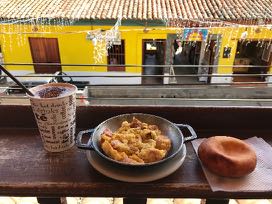 typical-colombian-breakfast.jpg A typical Colombian breakfast: scrambled eggs with onion, tomato and sausage, bread made from corn flour, and a café con leche